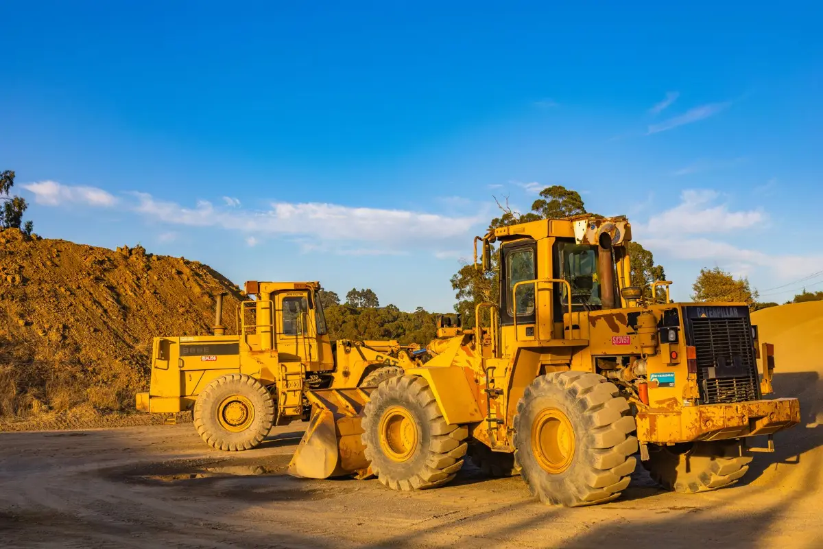 A wheel loader working a pile of excavated earth