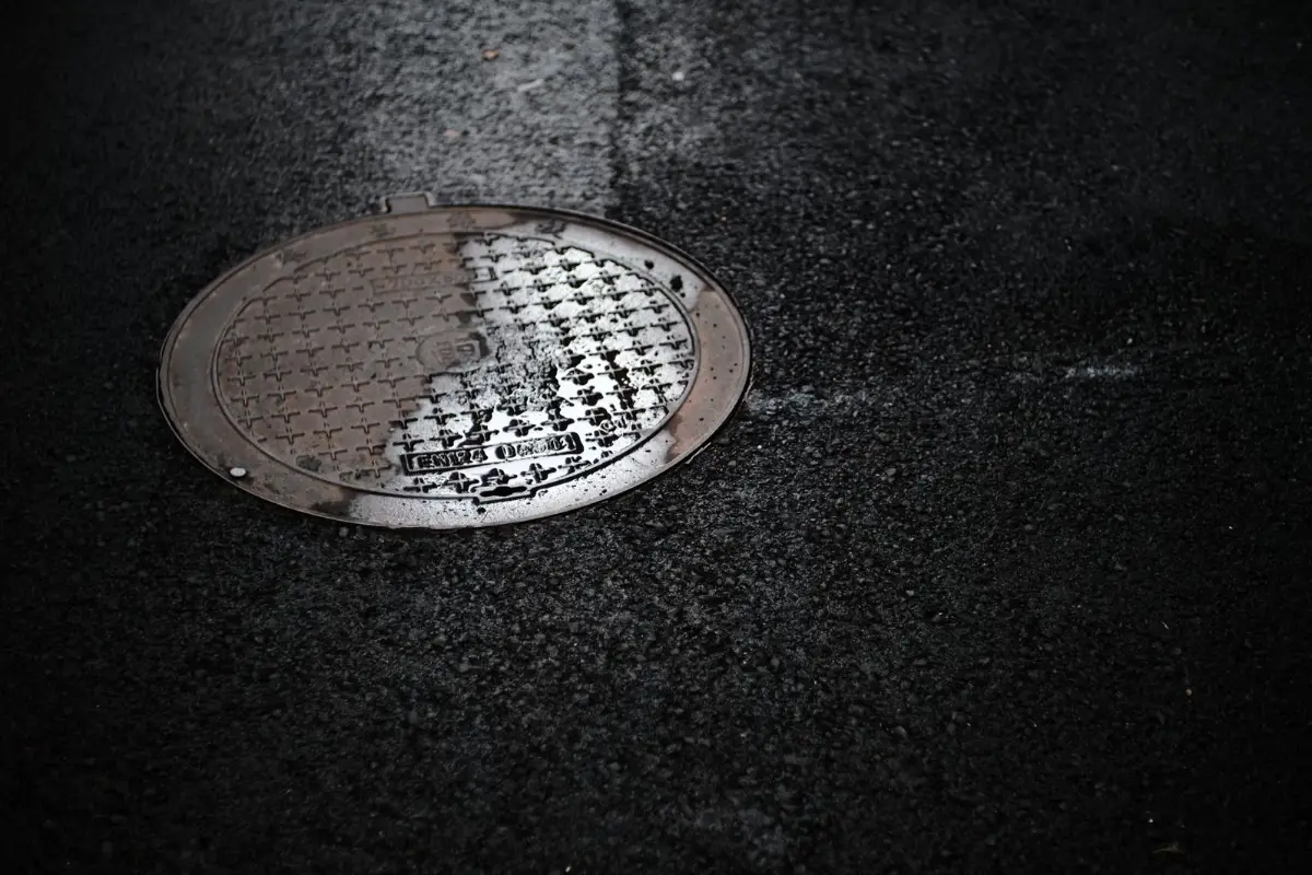 A manhole cover set into pavement